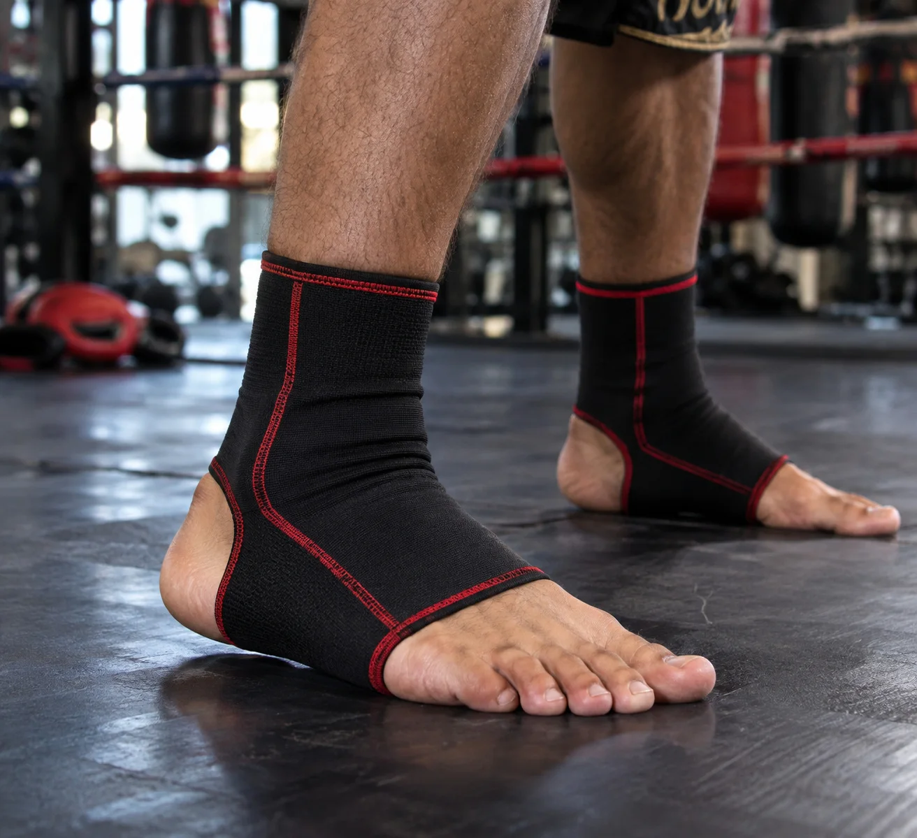 Black and red Muay Thai ankle supports worn during training