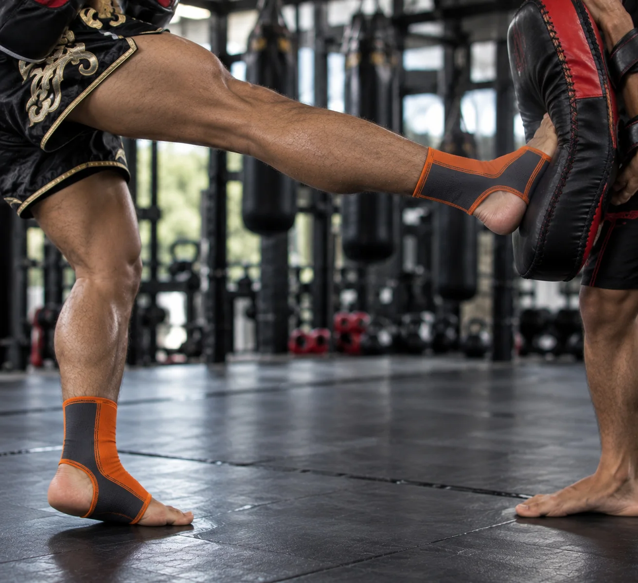 Orange ankle supports during striking action