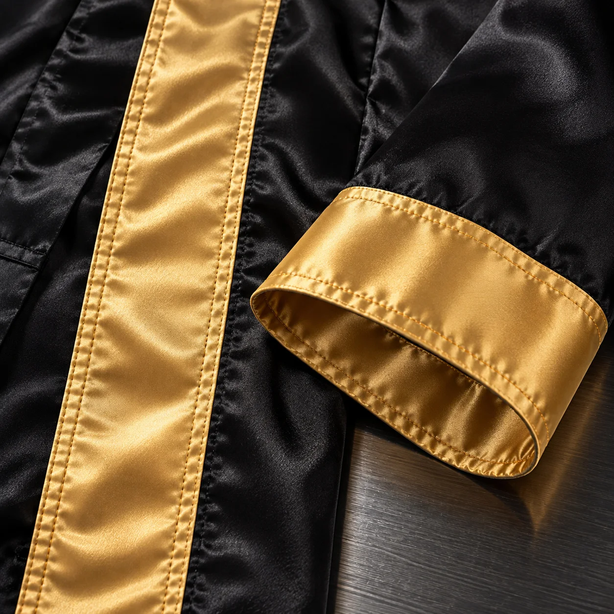 Close-up detail of satin boxing robe cuff and trim
