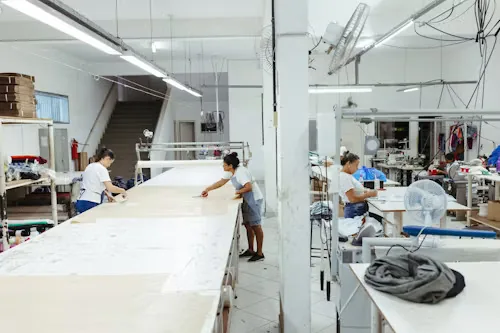 Fabric laid out and cut on the main cutting table at our Sialkot factory