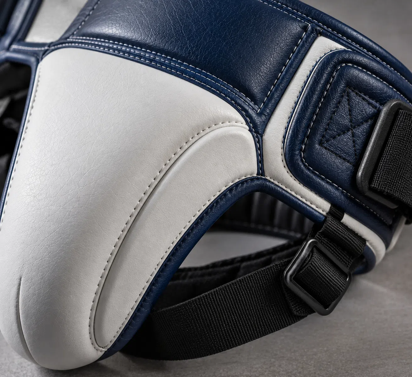 Close-up detail of white and blue groin guard construction