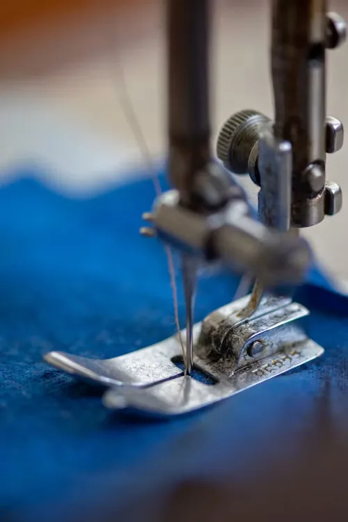 Industrial sewing machine needle stitching blue performance fabric