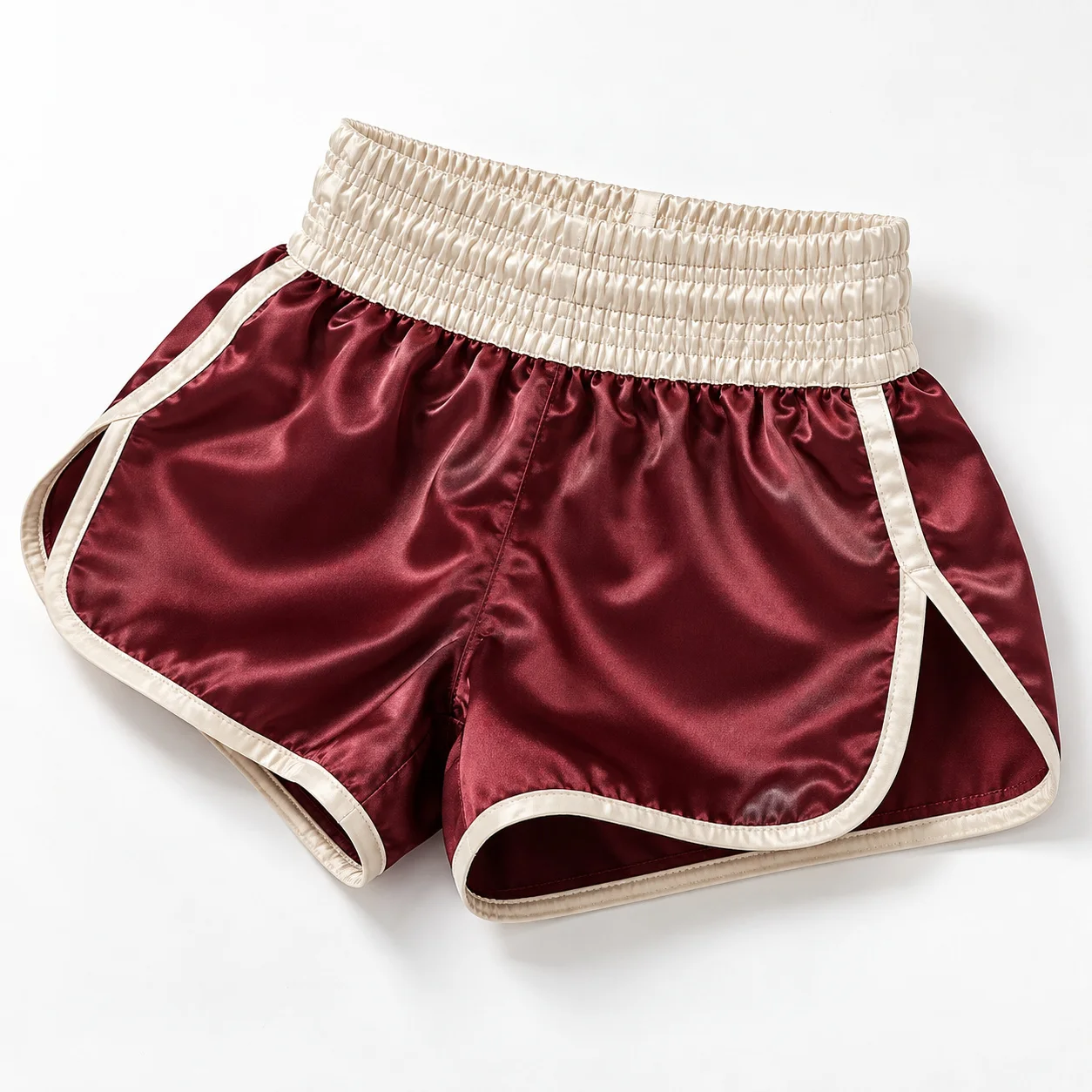 Burgundy and cream Muay Thai shorts flat lay