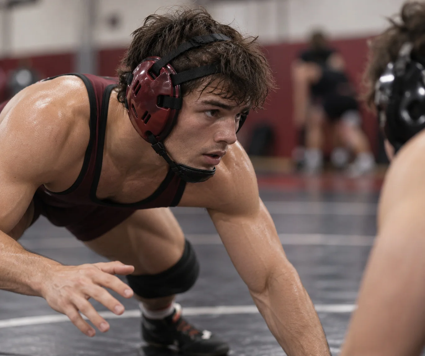 Maroon wrestling headgear worn during mat action